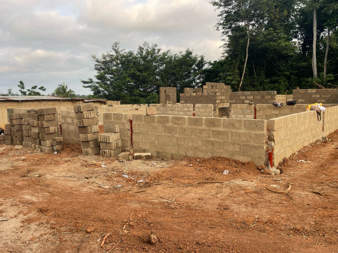 Block walls laid out on the foundation, marking the rooms of the building.