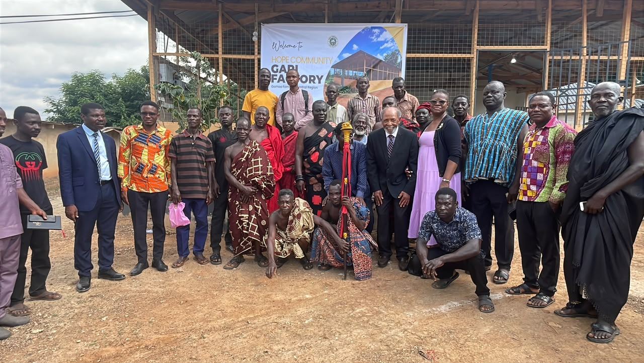 Chiefs, elders and community members posing together in front of the factory at its inauguration.